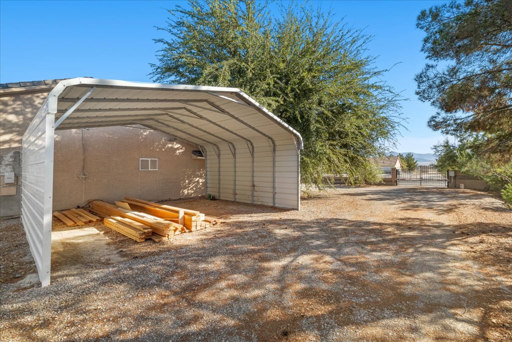 Covered High-Clearance RV Port Beside Residence at 3780 S Ranger Way
